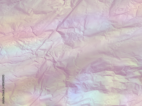 Crumpled paper texture with colorful holographic gradient. Abstract background in grunge style. 