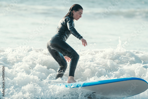 rookie woman surfing the wave portrait © oscargutzo