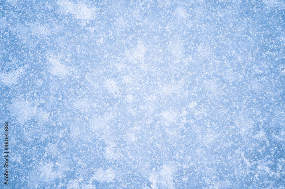 The texture of blue ice with white frost and reflected natural light. Background