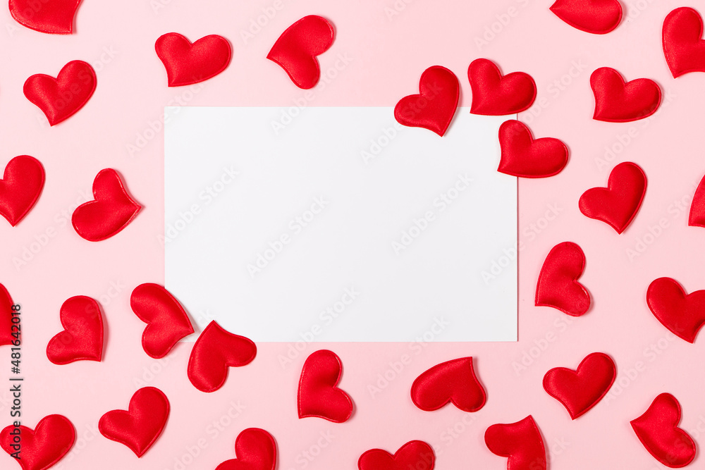 Blank greeting card and hearts for valentine's day. Mock up on a pink background.