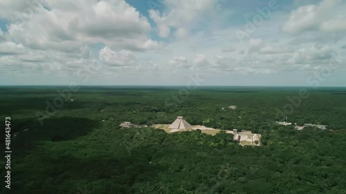 Mesoamerican El Castillo mayan pyramid in green jungle of Mexico, aerial photo