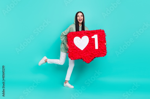 Full body photo of impressed young brunette lady hold like wear sweatshirt trousers footwear isolated on teal background