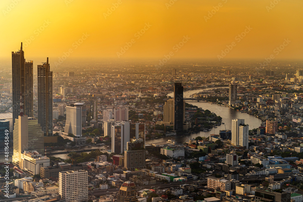 Fototapeta premium Modern Skyscraper of business center district at Bangkok skyline with sunset or sun rise sky background, Bangkok city is modern metropolis and favorite of tourists of Thailand