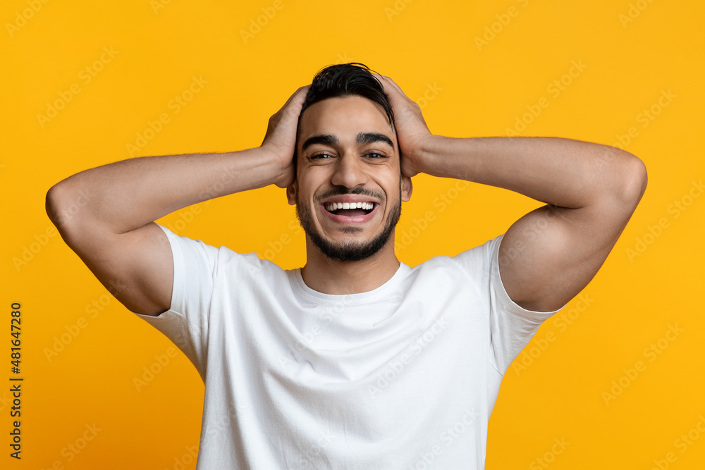 Super happy middle-eastern guy smiling and touching his head Super happy middle-eastern guy smiling and touching his head