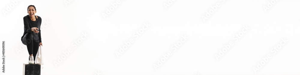 Fototapeta premium Happy young african sportswoman resting with towel