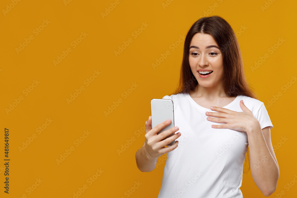 Emotional beautiful woman having video chat, using smartphone Emotional beautiful woman having video chat, using smartphone