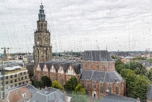 Scenic view of Martini church from through windows with raindrops of Forum building in the center of city of Groningen in The Netherlands