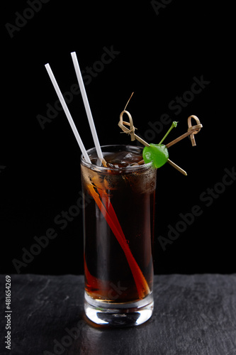 Alcoholic drinks at the bar. Bartender's hands in the process of making drinks.