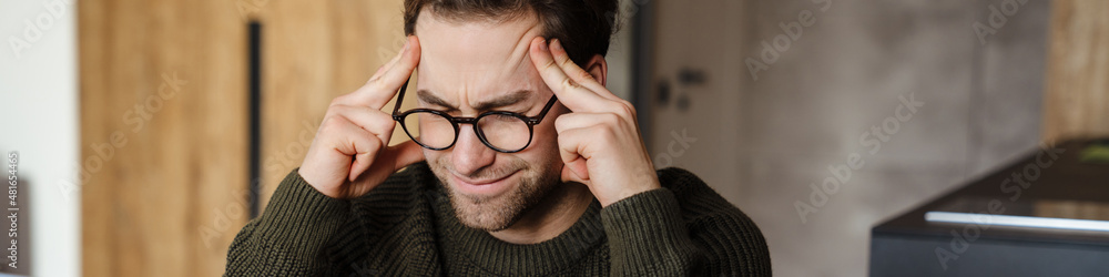 Obraz premium Mid aged man working on laptop computer from home