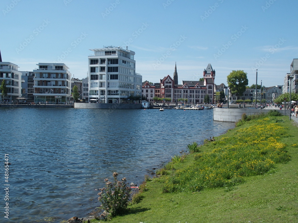 Obraz premium Modern and historic buildings and the marina at Phoenix Lake in the Dortmund suburb of Hoerde, North Rhine-Westphalia, Germany