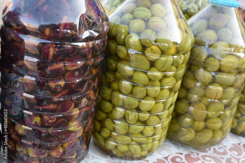 Large pickled olives in a large jar.