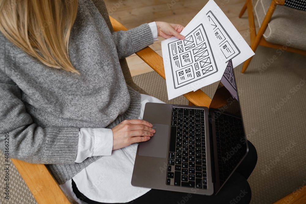 Woman designer create website design wireframe. Sketch, prototype, framework, layout future design project. UI and UX - user interface, user experience designer. Creative concept for web design studio