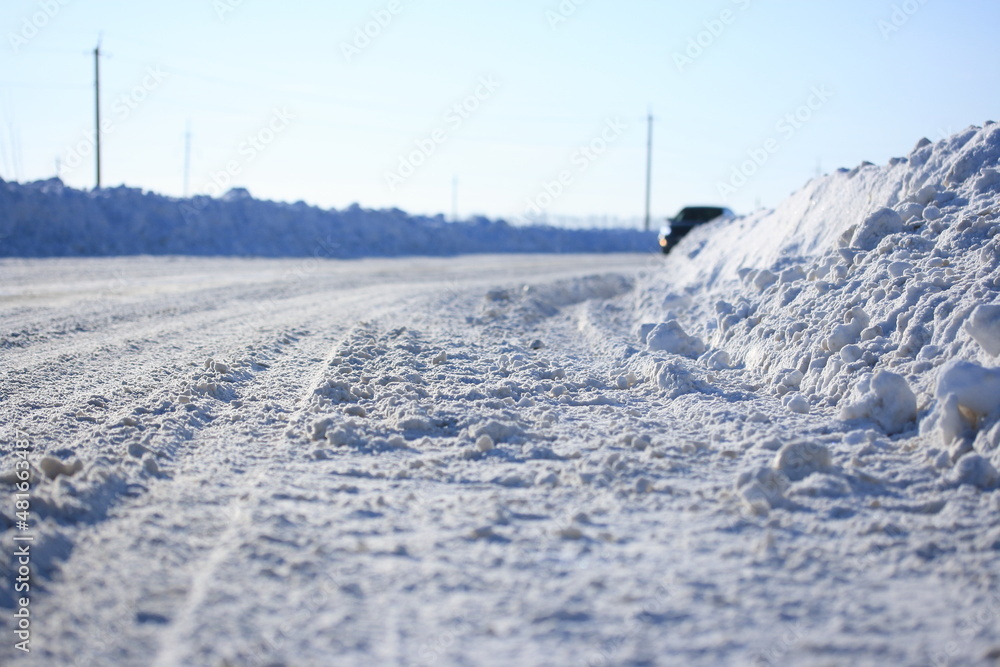 Road cleared of snow on a sunny winter day Road cleared of snow on a sunny winter day