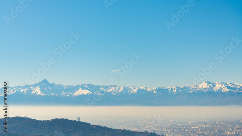 Aerial view of the city of Torino (Turin), Piedmont, Italy, from the hill where the Basilica di Superga (meaning: Superga's Cathedral), lies. Blue sky on the background withcopy-space. © Travelling Jack