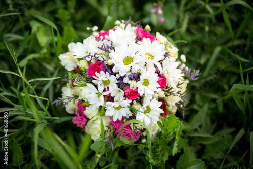 
Bouquet of flowers from roses and daisies, flowers for the day of everything, wedding bouquet, flowers for the bride, wedding accessories.