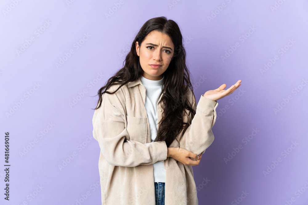 Young caucasian woman isolated on purple background having doubts Young caucasian woman isolated on purple background having doubts
