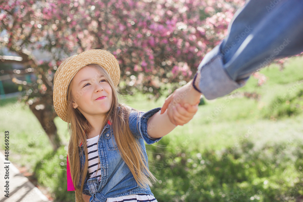 Young mother and her little cute daughter having fun outdoors. Family girls together.