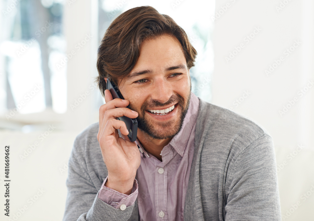 Staying in touch via cellphone. A handsome young man talking on his cellphone. Staying in touch via cellphone. A handsome young man talking on his cellphone.
