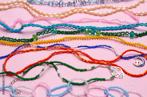 Fotografie, Obraz Beautiful handmade beaded necklaces on pink background