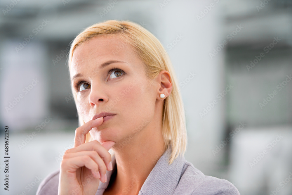 Thinking about business. Cropped shot of an attractive young businesswoman looking thoughtful. Thinking about business. Cropped shot of an attractive young businesswoman looking thoughtful.