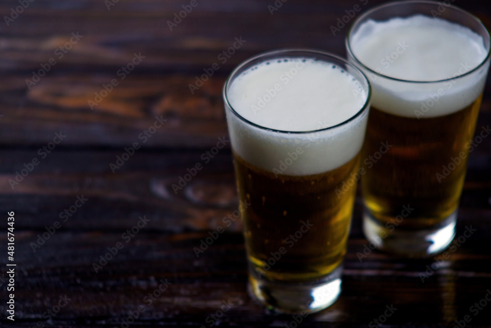 a large glass of cold light beer with foam on a dark background. St.Patrick 's Day a large glass of cold light beer with foam on a dark background. St.Patrick 's Day