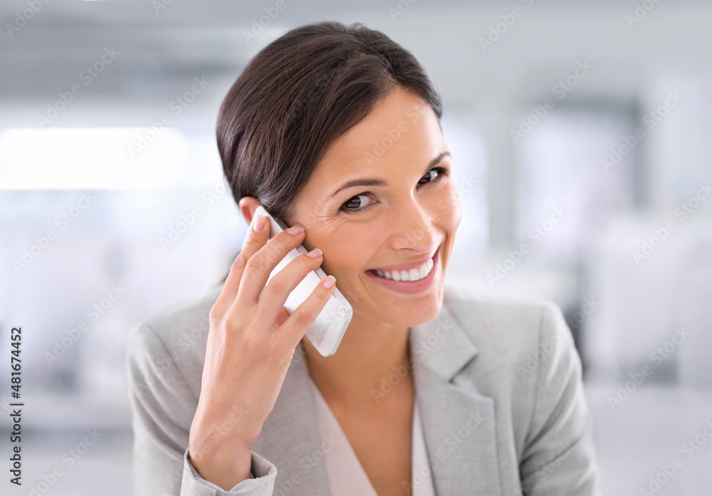 She's always available. Shot of a woman using a cellphone while sitting at a desk in an office. She's always available. Shot of a woman using a cellphone while sitting at a desk in an office.