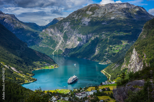 Cruise ships stand in the harbor of the Geiranger fjord, Norway photo