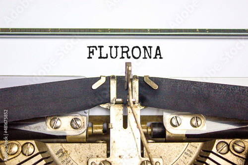 Covid-19 corona and flu flurona symbol. The concept word flurona typed on retro typewriter. Beautiful white background. Medical covid-19 corona and flu flurona concept. Copy space.