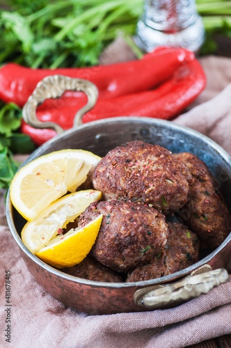 Fried minced meat kofta or kebabs served with vegetable saladf in a bowl. Close up. Middle eastern food concept. photo