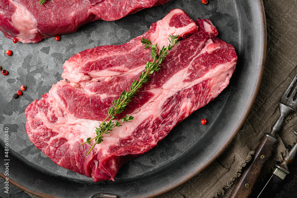 Beef steak, on black dark stone table background, top view flat lay