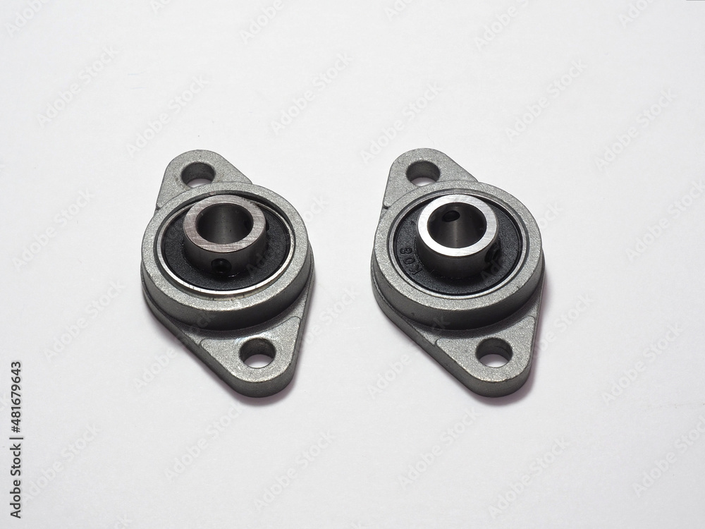 Metal ball bearing in housing. Two bolt flanged housing units. Ball bearings isolated on white Metal ball bearing in housing. Two bolt flanged housing units. Ball bearings isolated on white