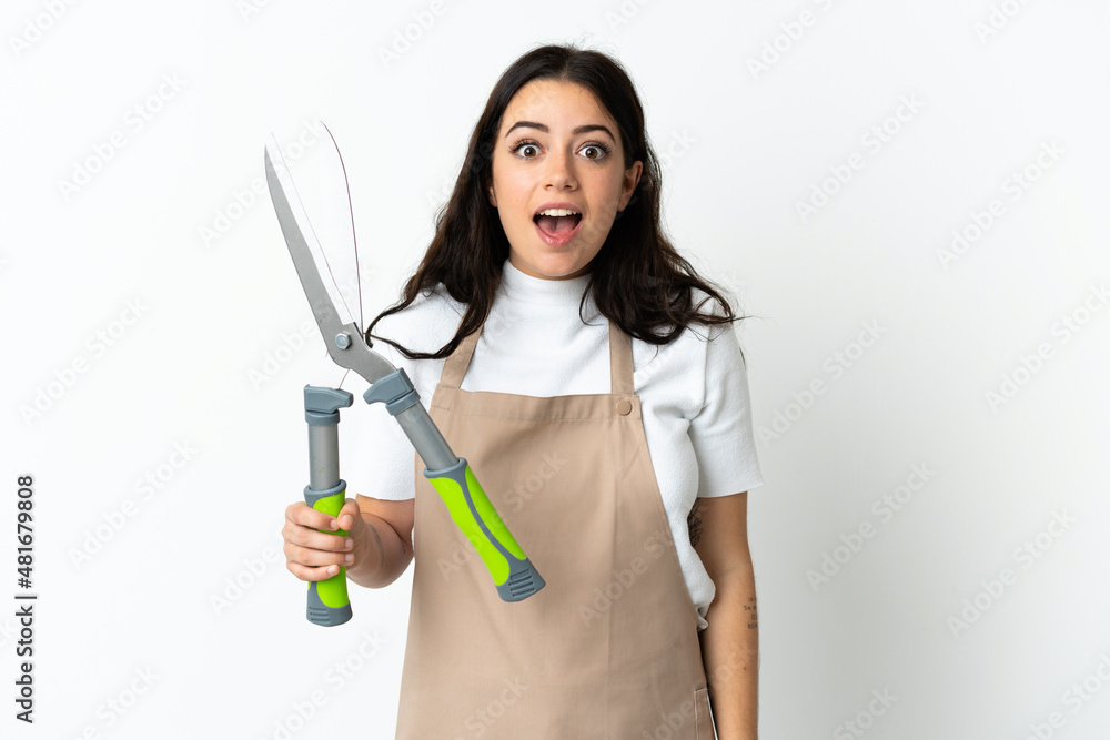 Young caucasian woman holding a plant isolated on white background with surprise facial expression Young caucasian woman holding a plant isolated on white background with surprise facial expression