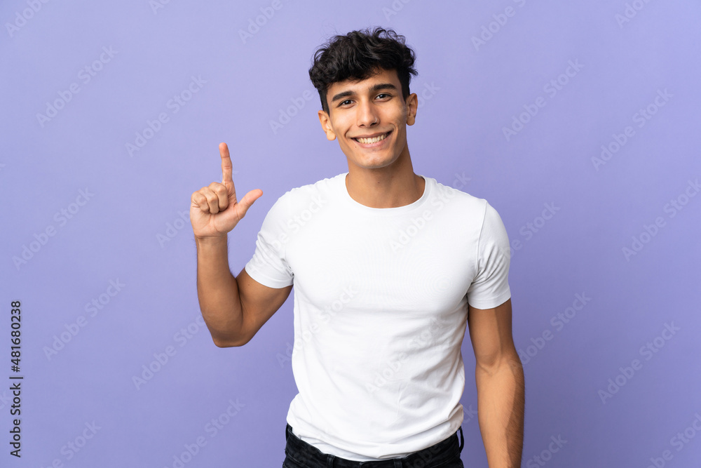 Young Argentinian man isolated on background pointing up a great idea Young Argentinian man isolated on background pointing up a great idea