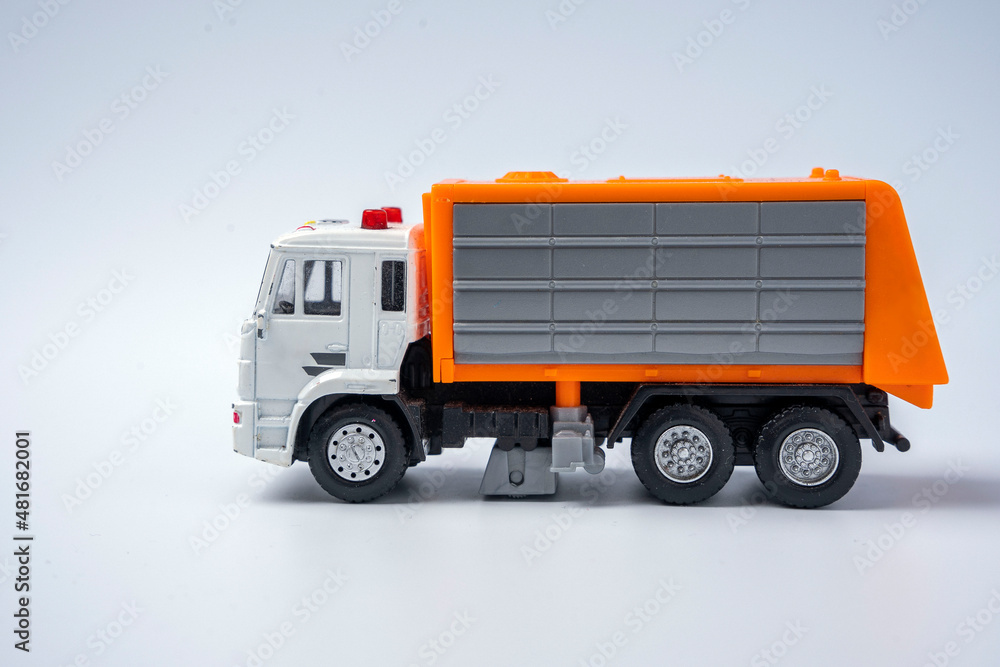 A toy garbage truck with an orange body on a white background.