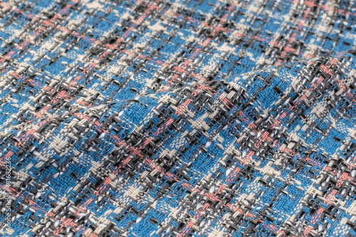 Blue checkered fabric with colored threads. Scottish wool. Fabric for a plaid coat and suit. Close-up. Background