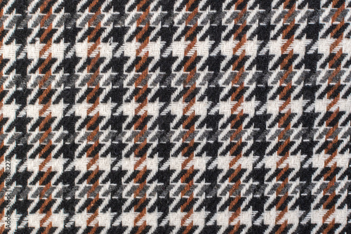 Classic tweed, Wool Background Texture. Coat close-up. Expensive men's suit fabric. Glenurquhart check is made of woolen fabric with a woven twill design of small and large checks. Houndstooth seamles