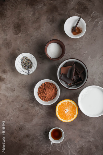 Ingredients for making spiced hot chocolate on a dark table. Flat lay with groceries