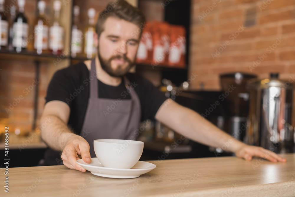 Barista with cup of coffee in cafe Barista with cup of coffee in cafe