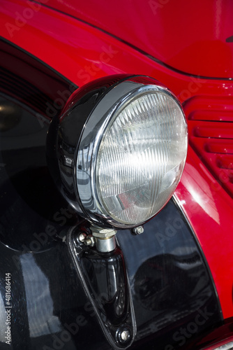 Retro red car headlight close up © mtv2021