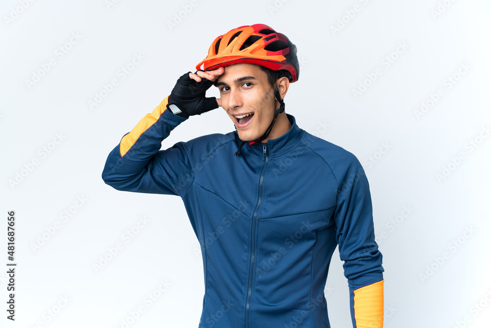 Young cyclist man isolated on background doing surprise gesture while looking to the side Young cyclist man isolated on background doing surprise gesture while looking to the side