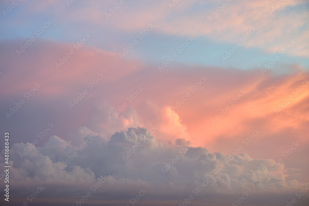 Colorful evening landscape with soft pastel coloured cloudscape on watercolor tinted sunset sky. Abstract nature background