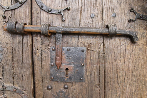 Photos Old metal bolt on a wooden door in a romanesque church in Perazancas, north of P