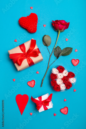 Valentine's Day background. Gifts, candle, confetti, envelope on pastel blue background. Valentines day concept.