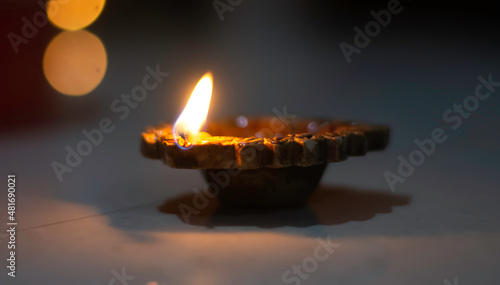 Burning earthen lamp(diya) in the dark during Diwali - an Indian festival of lights