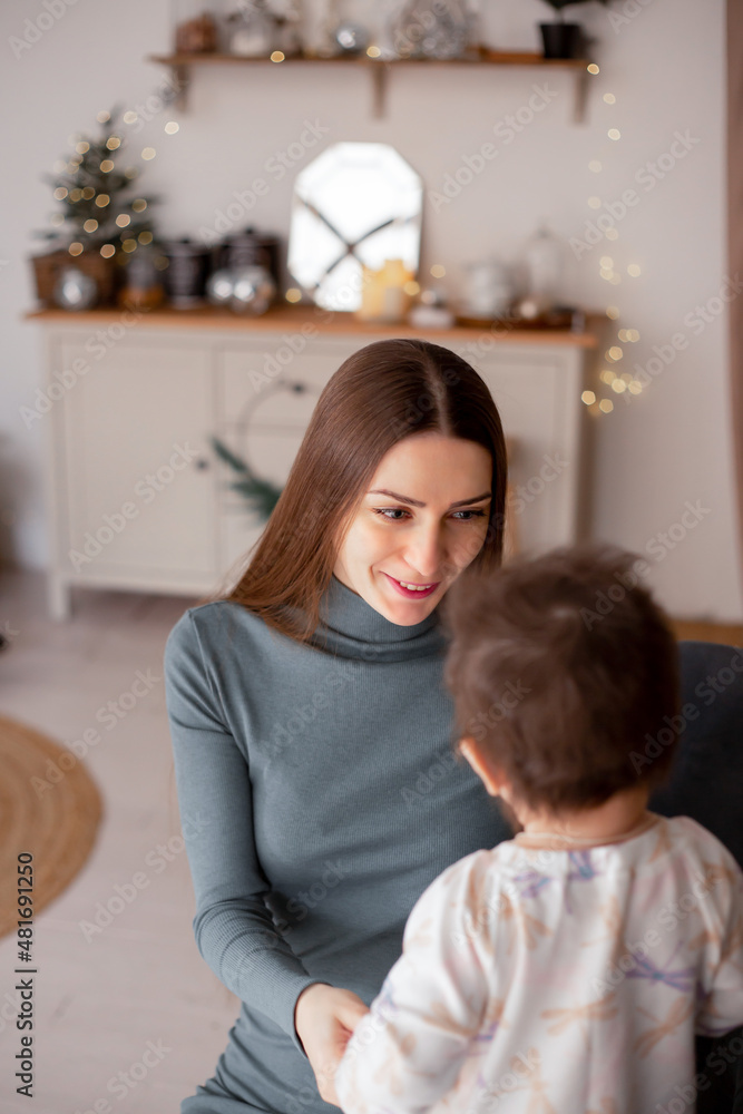 Happy loving family. Young mom and her beautiful daughter are looking at each other and holding hands Happy loving family. Young mom and her beautiful daughter are looking at each other and holding hands