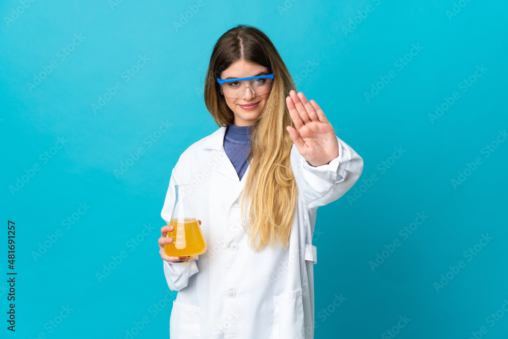 Young blonde scientific woman isolated on blue background making stop gesture Young blonde scientific woman isolated on blue background making stop gesture