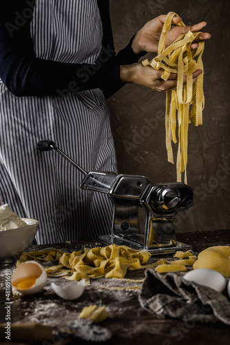 home made pasta machine with woman tagliatelli photo