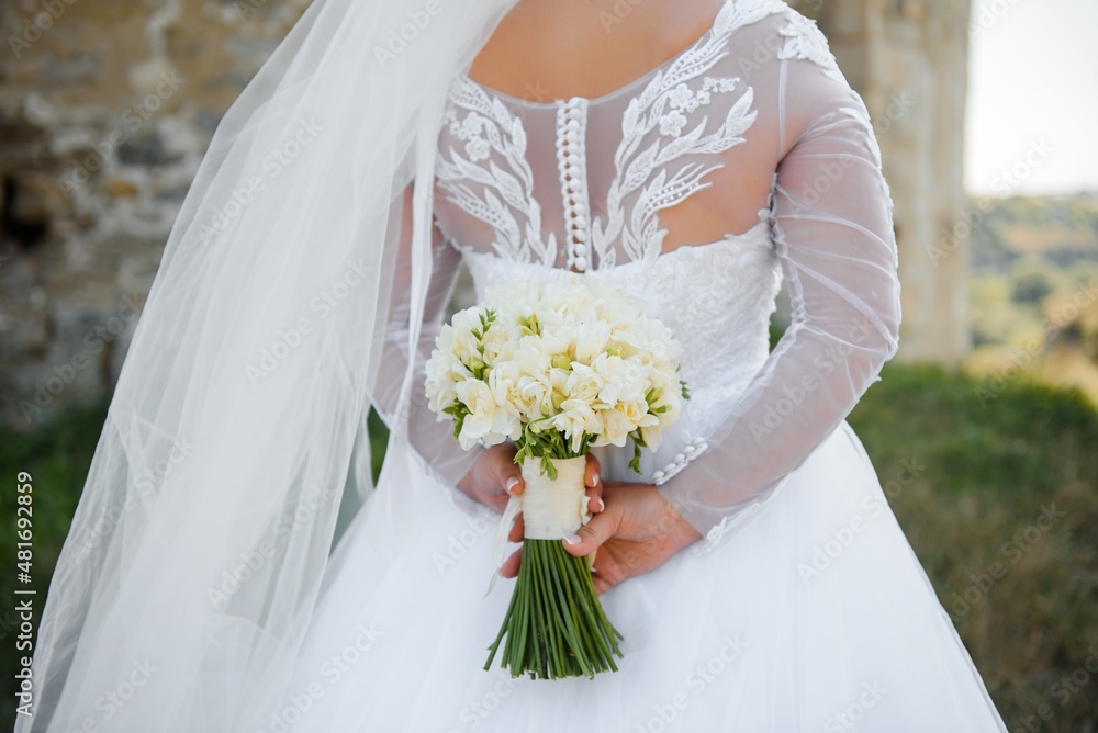 Bride holds a wedding bouquet, wedding dress, wedding details Bride holds a wedding bouquet, wedding dress, wedding details