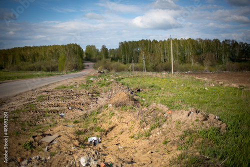 Piles of garbage in the field, garbage in the forest, environmental pollution, garbage on arable land.