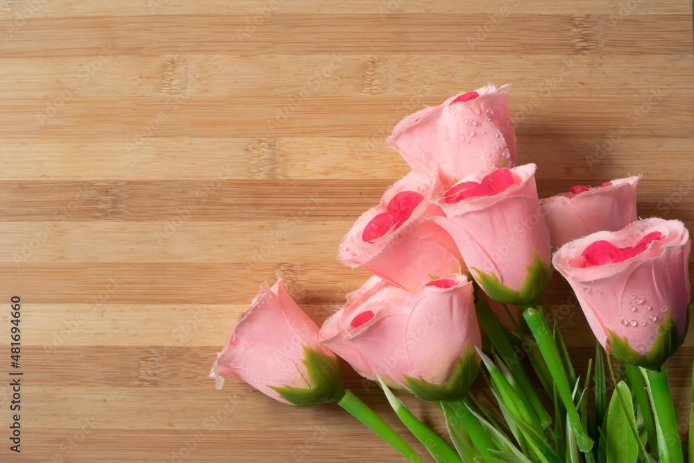 Valentine's Day background with bouquet of pink roses on wooden table. Valentine's Day background with bouquet of pink roses on wooden table.